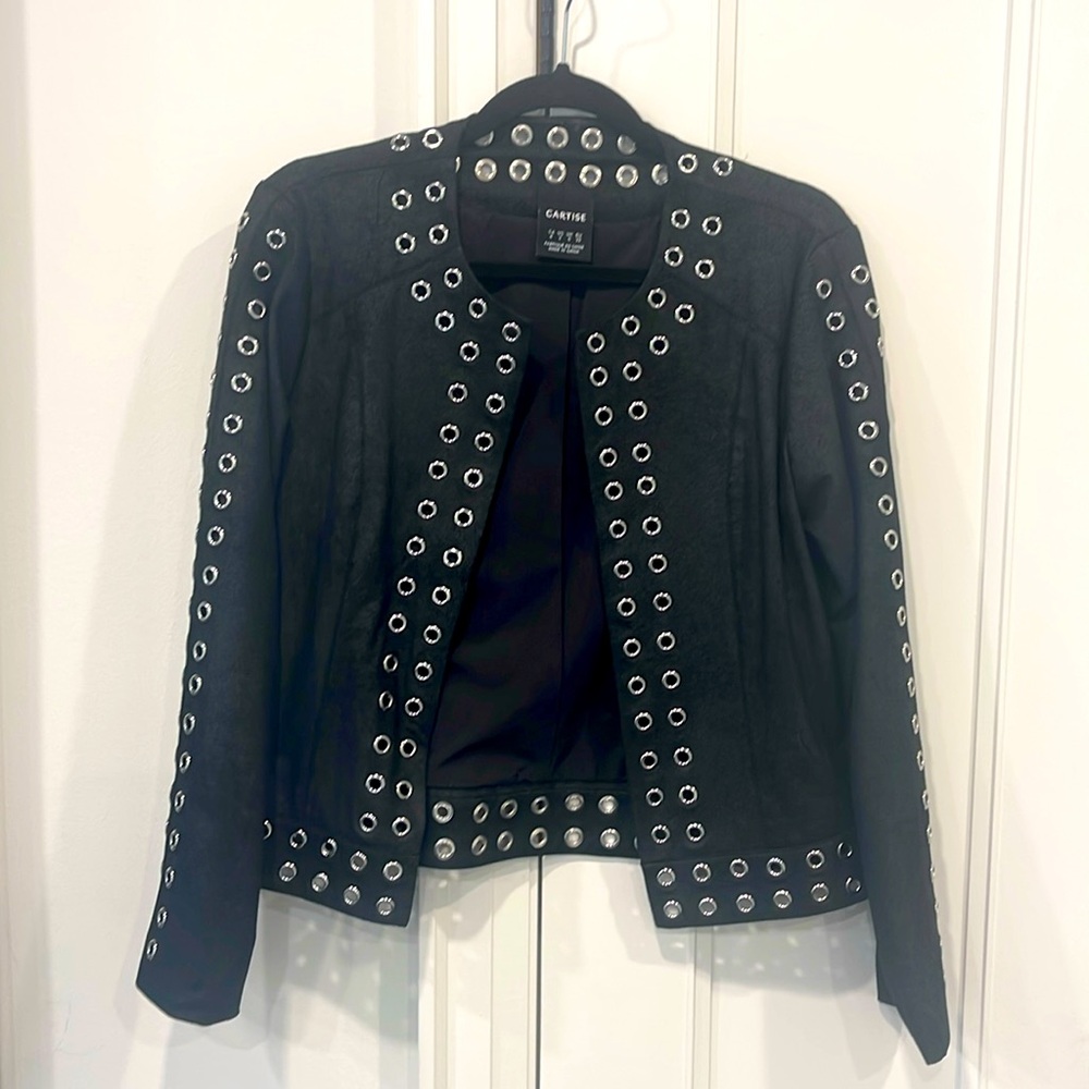 Faux suede. Black jacket with metal chrome decal.